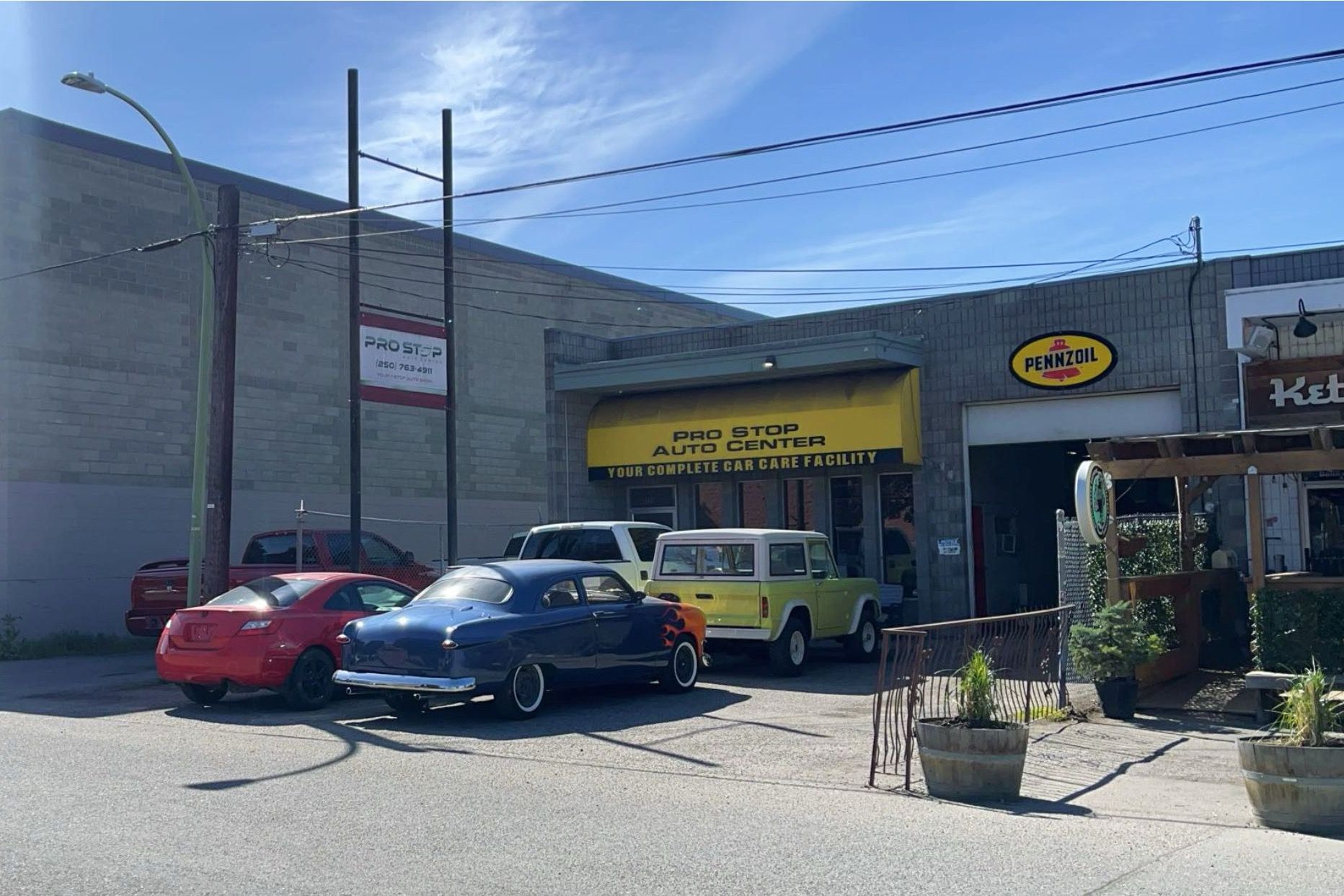 Pro Stop Auto Center's shop on Baillie Avenue with classic cars parked out front